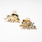 Gold and pearl leaf-shaped earrings on a white background. Harma Jewelry Olive Branch Of Hope Stud Earrings Full Cubic Zirconia Gold Plated