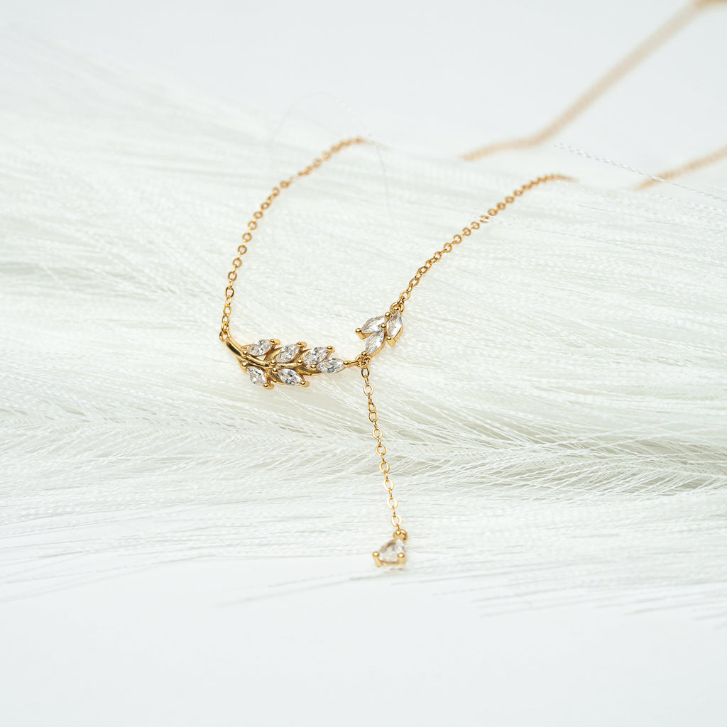 Gold necklace with a delicate design on a white background. Harma Jewelry gold plated I Am Flourishing Sterling Silver Zirconia Necklace