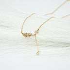 Gold necklace with a delicate design on a white background. Harma Jewelry gold plated I Am Flourishing Sterling Silver Zirconia Necklace