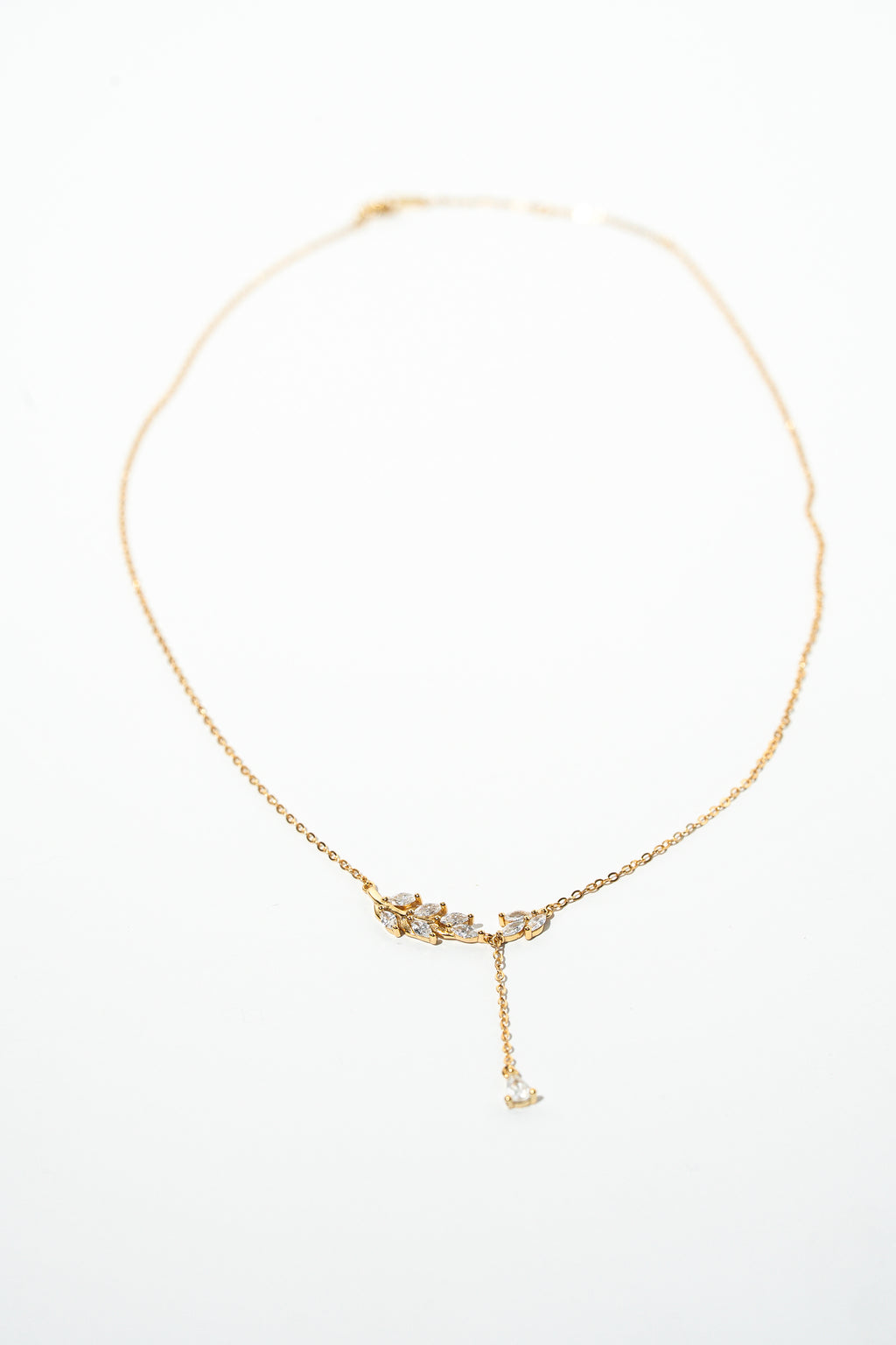 Gold necklace with a delicate pendant on a white background. Harma Jewelry gold plated I Am Flourishing Sterling Silver Zirconia Necklace