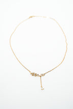 Gold necklace with a delicate pendant on a white background. Harma Jewelry gold plated I Am Flourishing Sterling Silver Zirconia Necklace