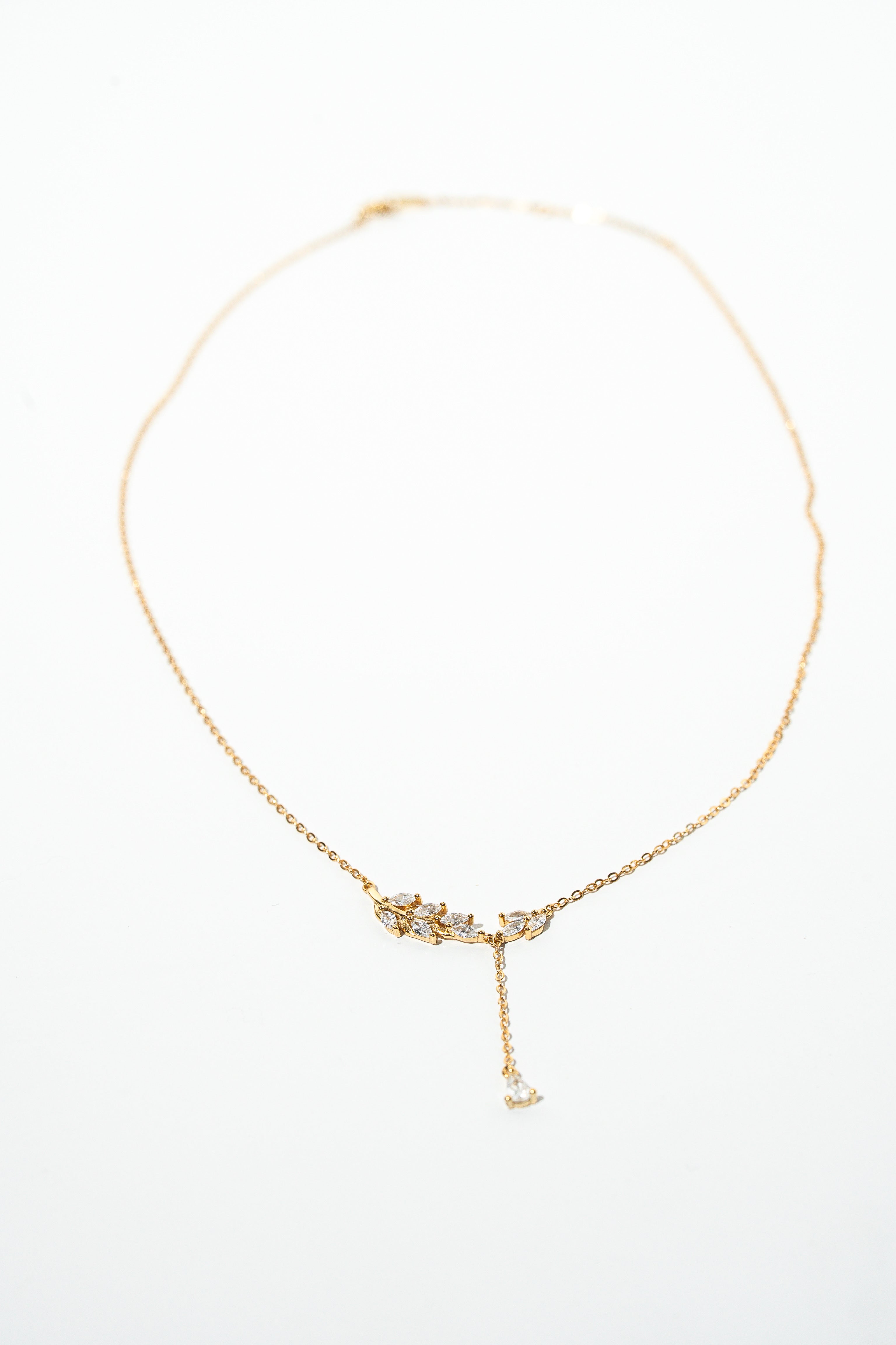Gold necklace with a delicate pendant on a white background. Harma Jewelry gold plated I Am Flourishing Sterling Silver Zirconia Necklace