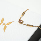 Gold bracelet with leaf design on a white background Harma Jewelry gold plated I Am Healing PINK Zirconia Bracelet