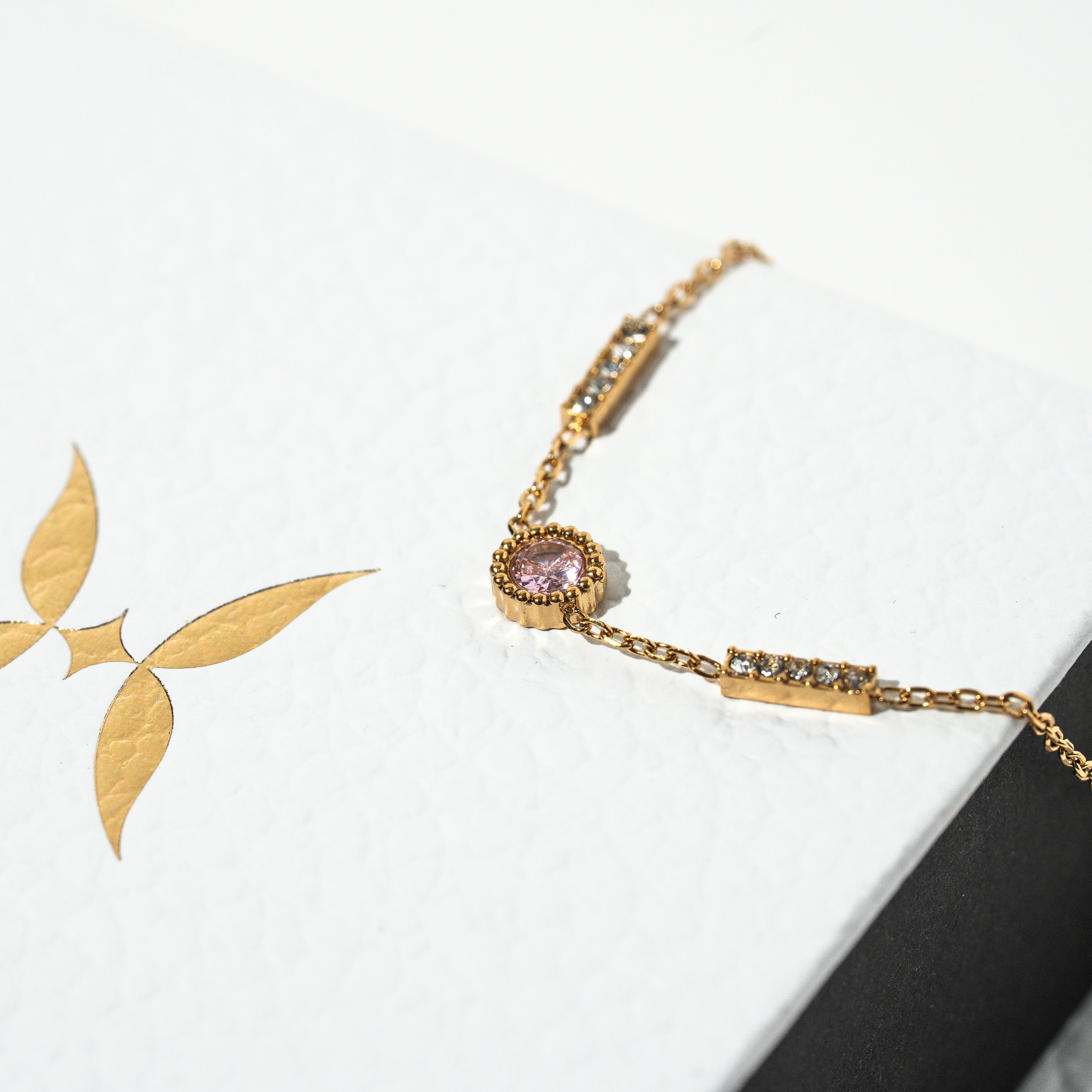 Gold bracelet with leaf design on a white background Harma Jewelry gold plated I Am Healing PINK Zirconia Bracelet