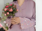 Person holding a bouquet of flowers wearing a purple dress with floral embroidery. Harma Luminous Noor Lantern Necklace Set