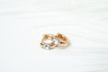 Rose gold ring with embedded gemstones on a white background