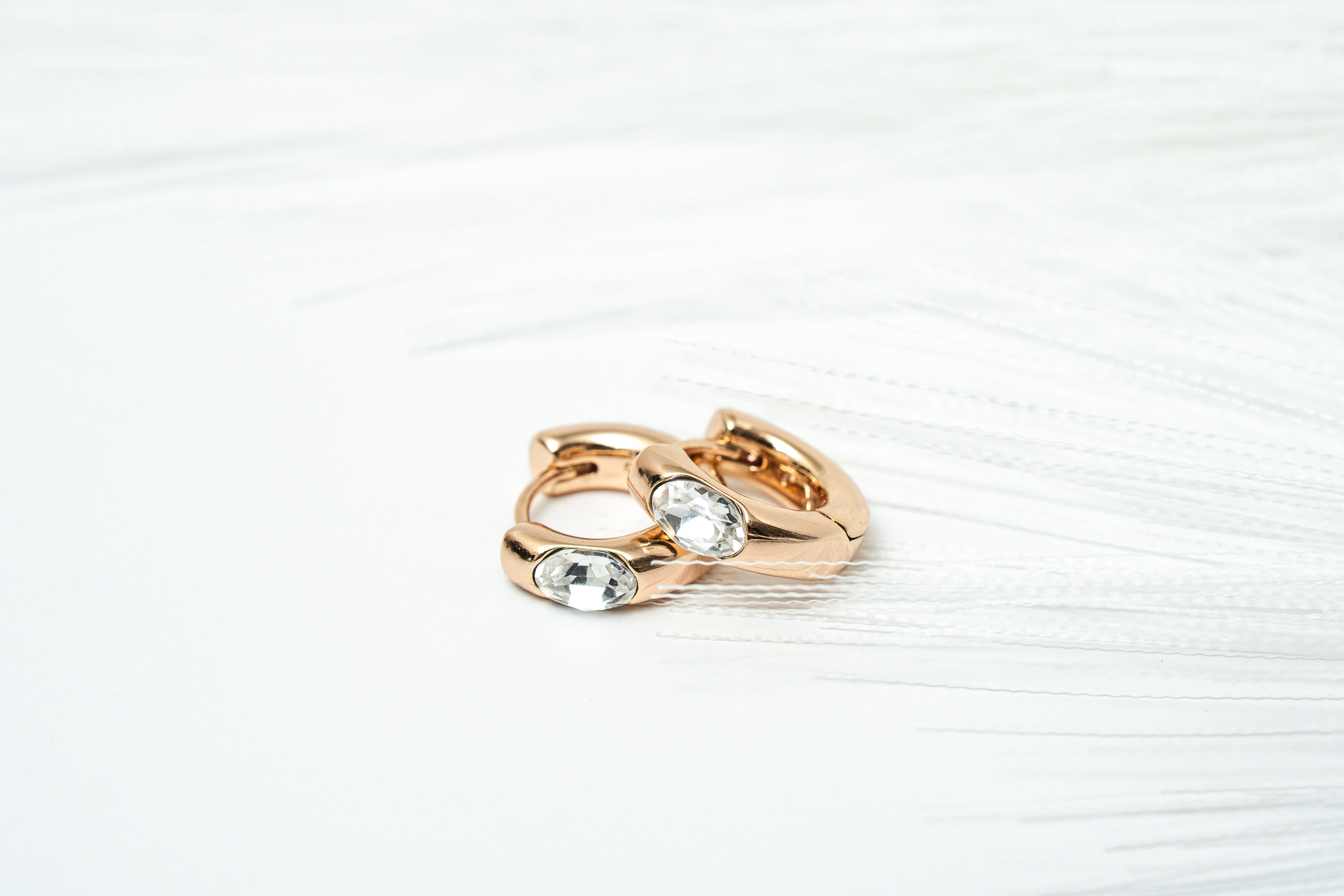 Rose gold ring with embedded gemstones on a white background