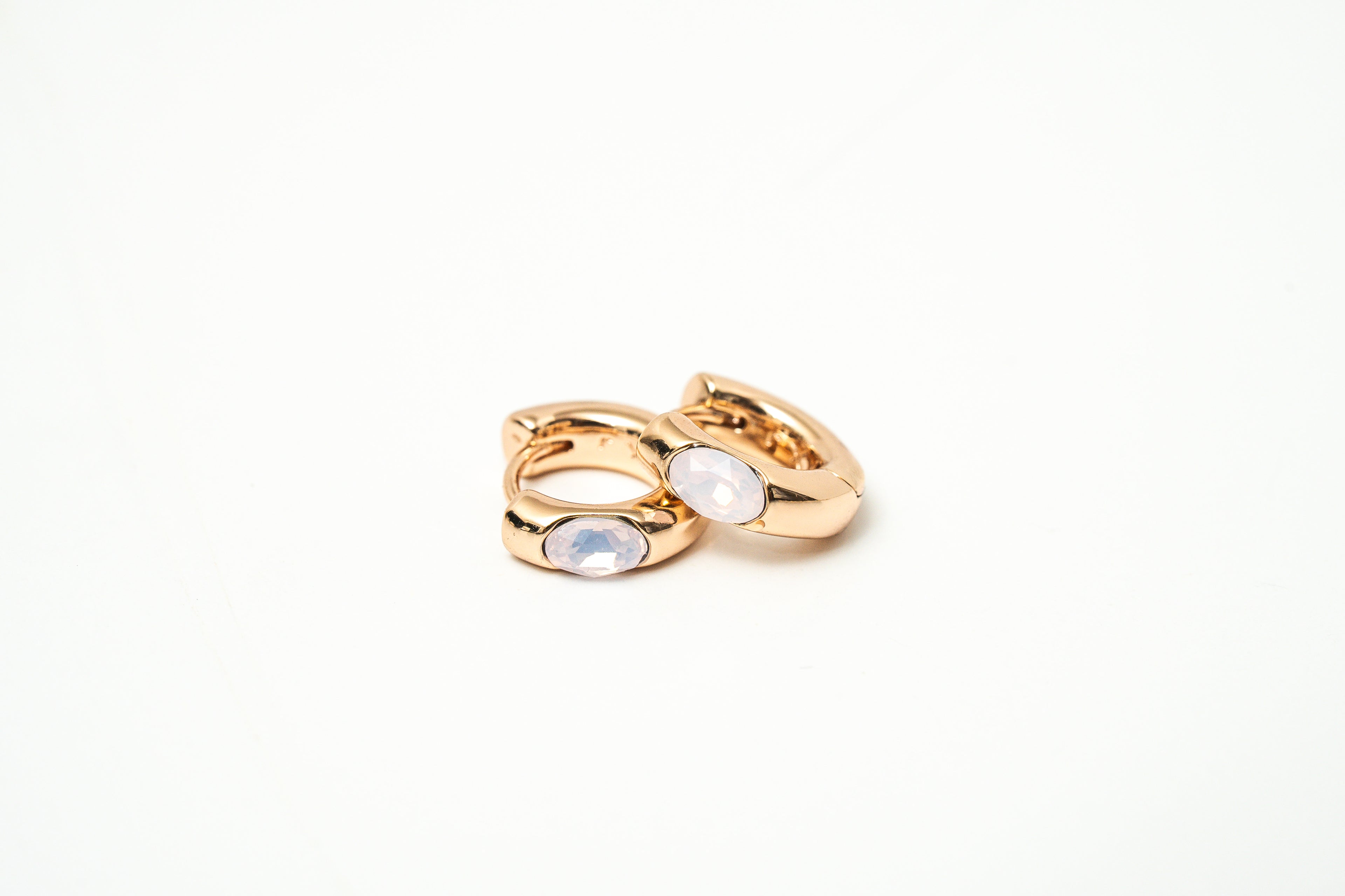 Gold ring with moonstone on a white background