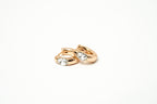 Pair of rose gold hoop earrings with clear gemstones on a white background