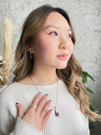 Harma jewelry platinum plated white gold teardrop necklace in three colors blue burgundy and white stones. Harma jewelry Droplets of Mercy Platinum Plated Teardrop Necklace Pink Stones 