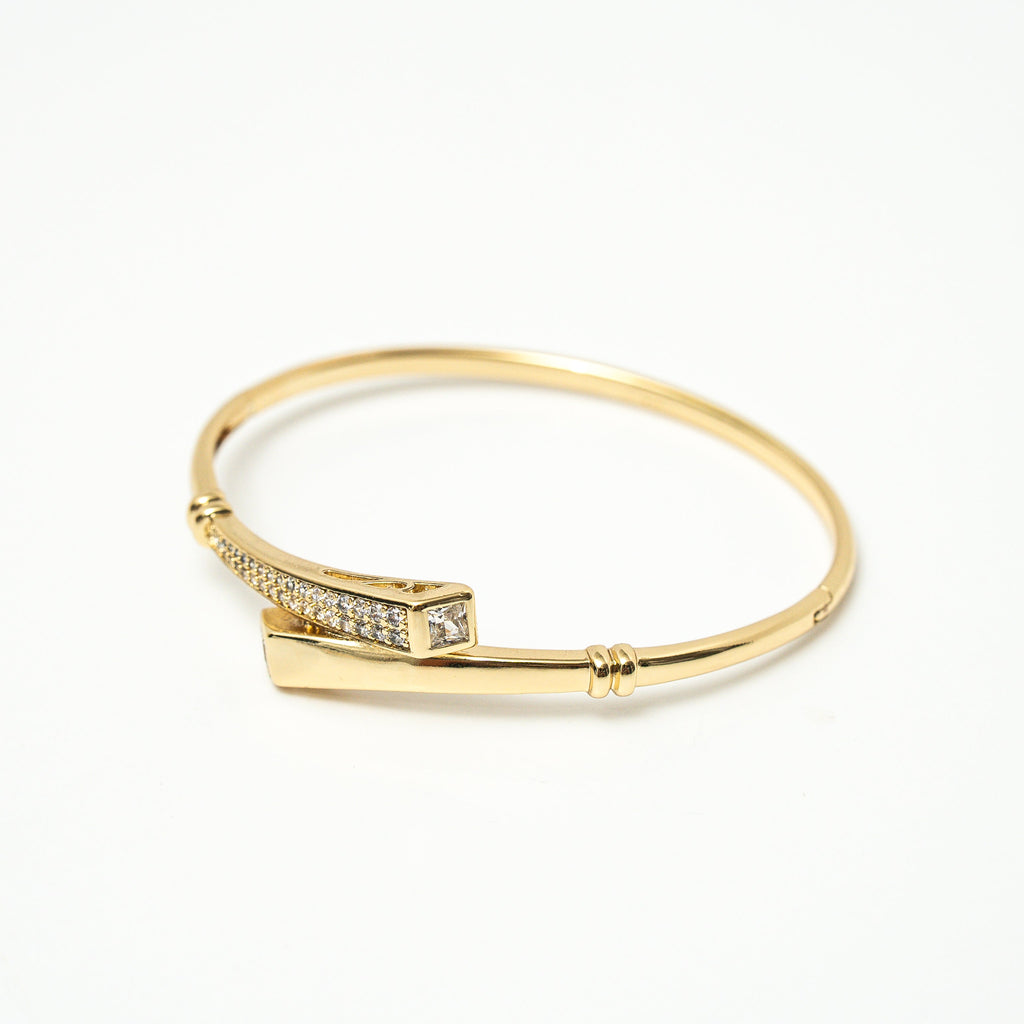 Gold bracelet with small diamonds on a white background. Harma jewelry Gold plated I Am Whole Again Bangle Bracelet