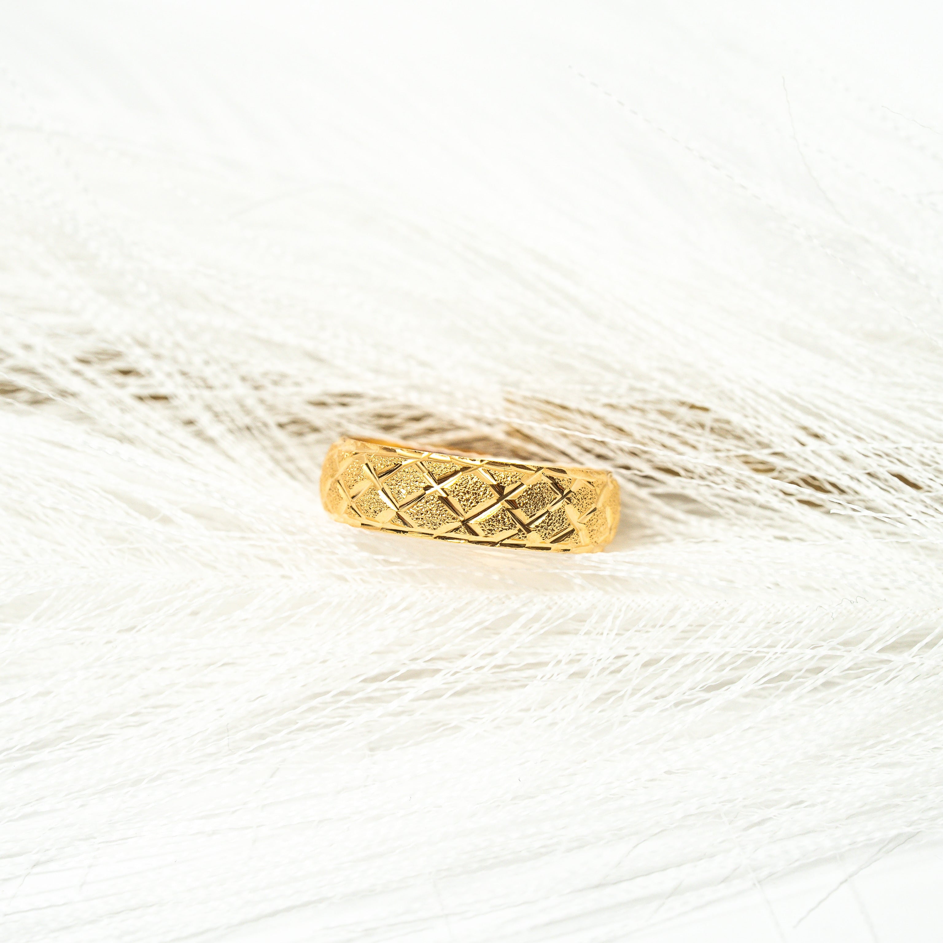 Gold ring with a textured band on a white background. Harma_Jewelry_Timeless_Bands_24K_Gold-Plated_Adjustable_Rings_2