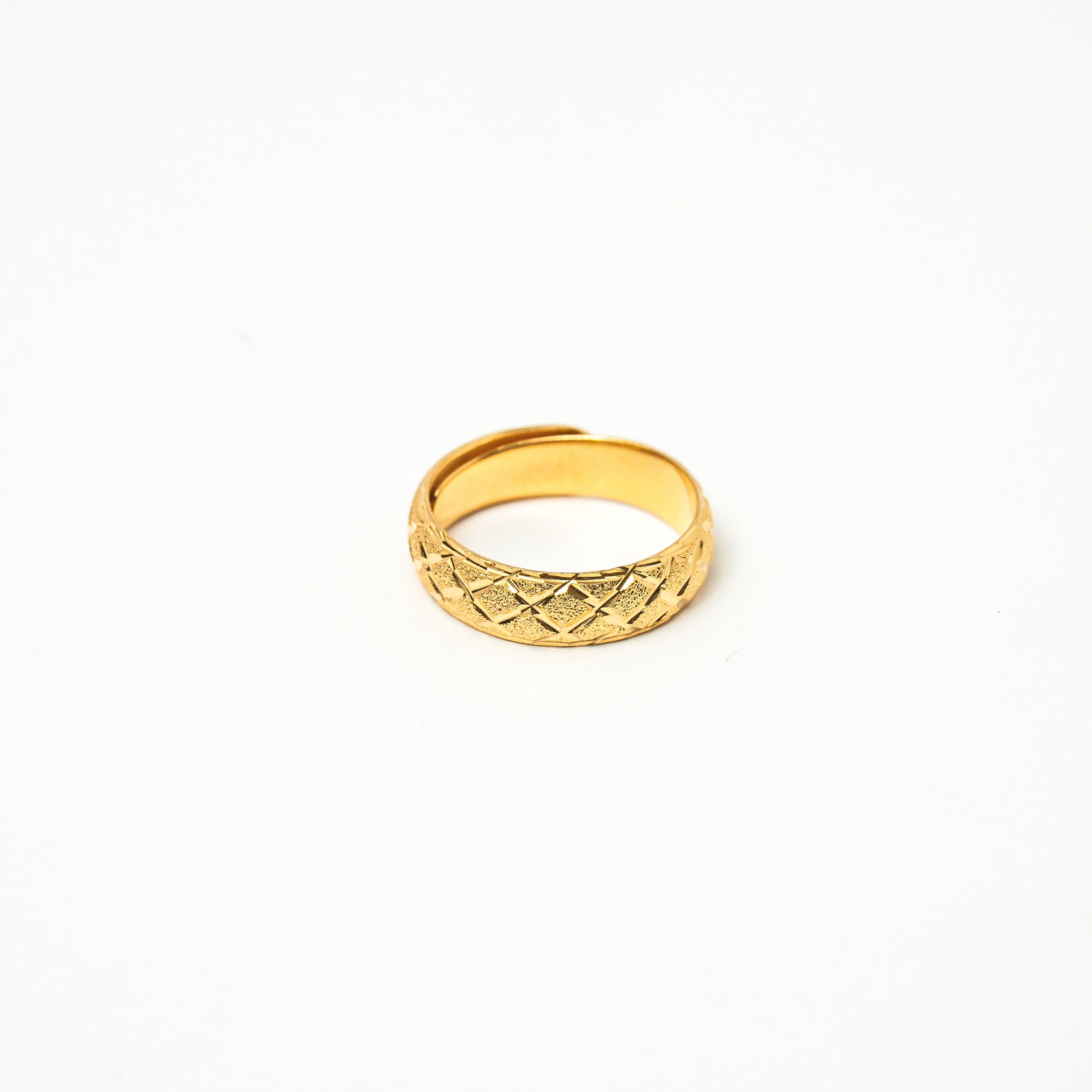 Gold ring with a textured pattern on a white background. Harma_Jewelry_Timeless_Bands_24K_Gold-Plated_Adjustable_Rings_2