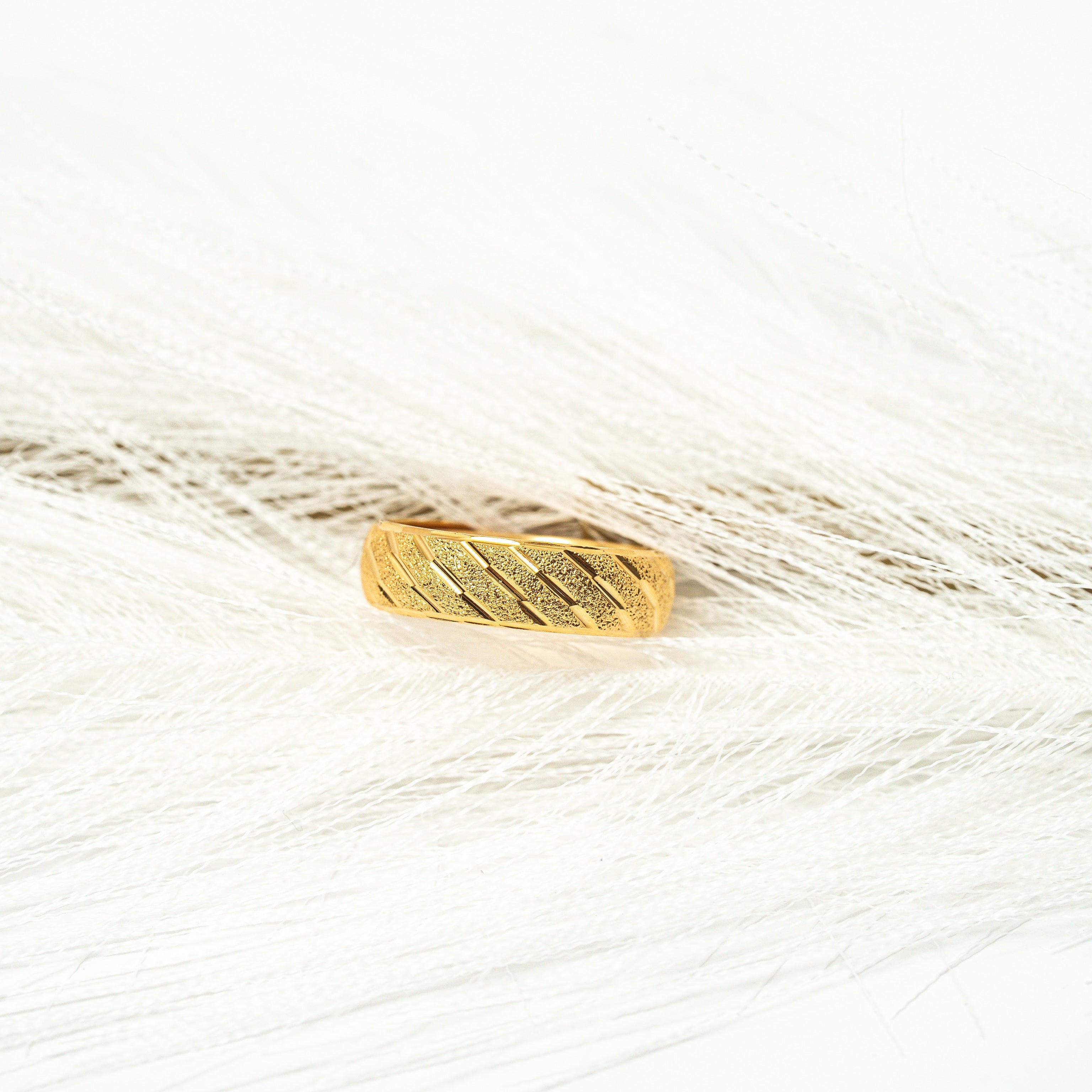 Gold ring on a white background. Harma_Jewelry_Timeless_Bands_24K_Gold-Plated_Adjustable_Rings_2