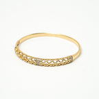 Gold bracelet with intricate design on a white background. Harma jewelry gold plated Golden Heritage Bangle Bracelet