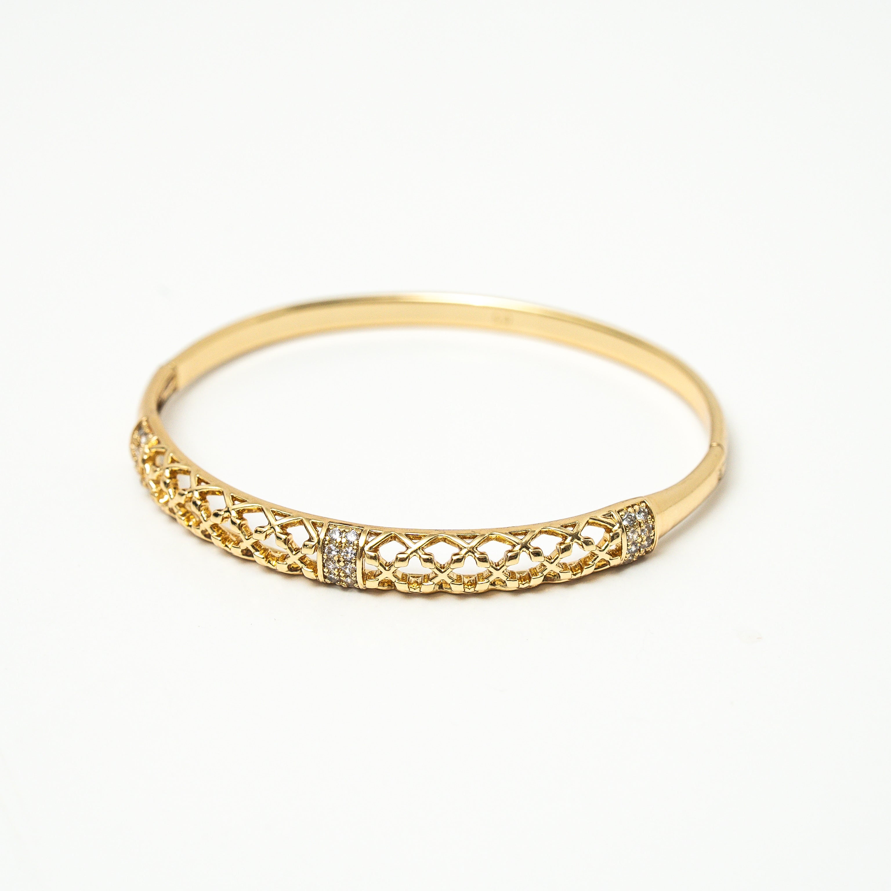 Gold bracelet with intricate design on a white background. Harma jewelry gold plated Golden Heritage Bangle Bracelet