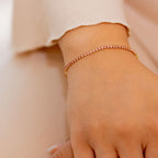 Close-up of a hand wearing a rose gold bracelet on a blurred background I Am Becoming PINK Link Bracelet