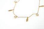 Gold anklet with feather and round charm on a white background. Harma jewelry gold plated I Am Light Feather Bracelet