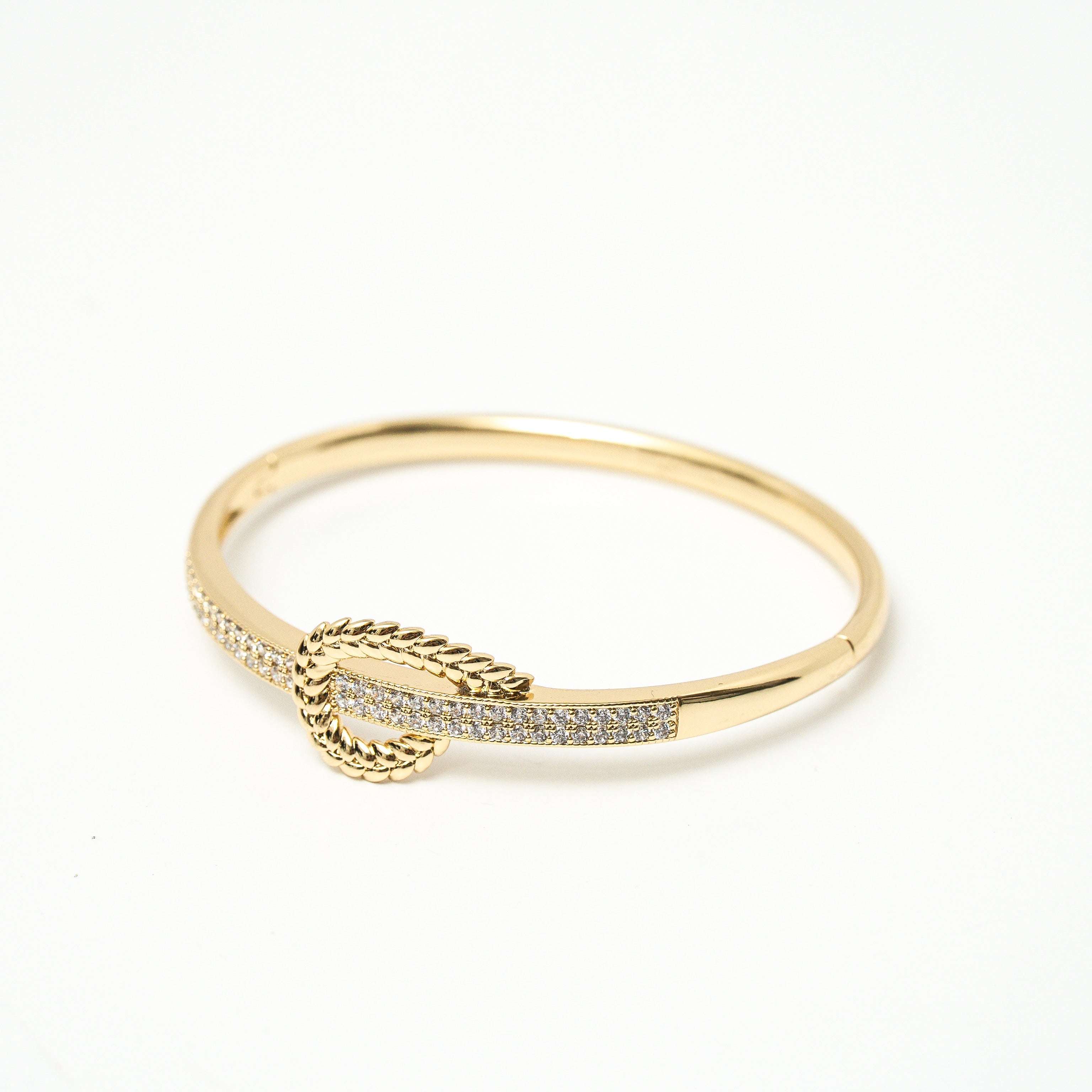 Gold bracelet with a decorative element on a white background. Harma jewelry gold plated I Am at Peace Vine Hoop Bangle Bracelet