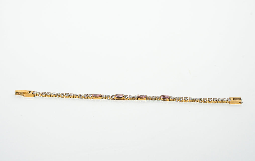Gold bracelet with diamonds on a light gray background. Harma jewelry gold plated Moments of PINK Tennis Bracelet
