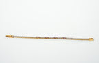 Gold bracelet with diamonds on a light gray background. Harma jewelry gold plated Moments of PINK Tennis Bracelet