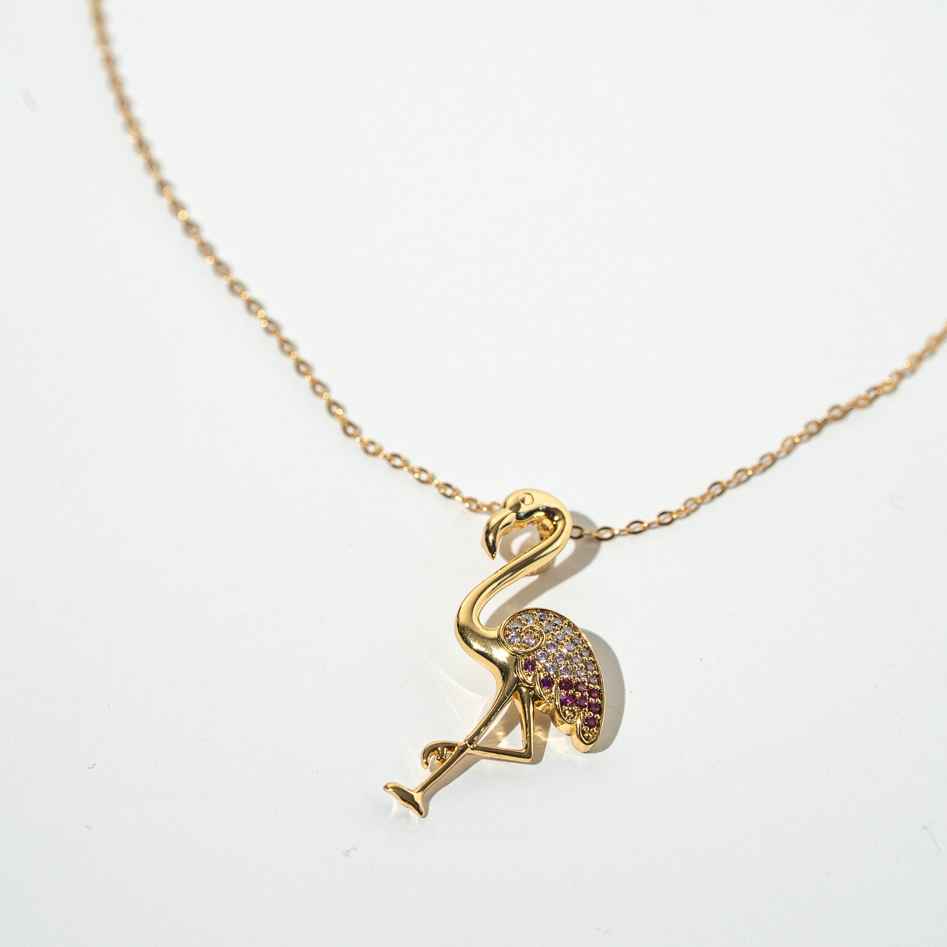Gold necklace with a flamingo pendant on a white background Harma jewelry s925 I Am Becoming PINK Again Flamingo Necklace 1