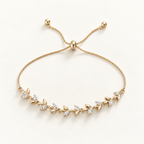 A delicate gold adjustable chain bracelet featuring a leafy vine design with small clear crystal accents, displayed on a clean off-white background. Whispering Magnolia Marquise Adjustable Bracelet 18k gold plated Harma Jewelry