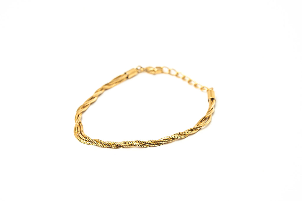 A gold-colored twisted rope chain bracelet with a lobster clasp, displayed on a clean white background. hARMA jewelry - I Am Evolving Twist 24K Bracelet