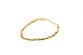 A gold-colored twisted rope chain bracelet with a lobster clasp, displayed on a clean white background. hARMA jewelry - I Am Evolving Twist 24K Bracelet